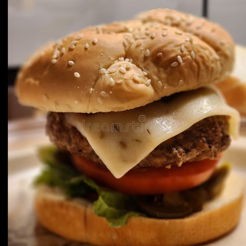 Giant Cheeseburger with Pepper Jack Cheese and Tomato Stock Photo