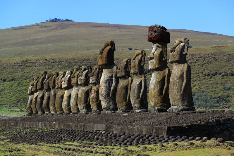 The giant Moai statues of Ahu Tongariki with Poike volcano in background, Archaeological site in Easter Island