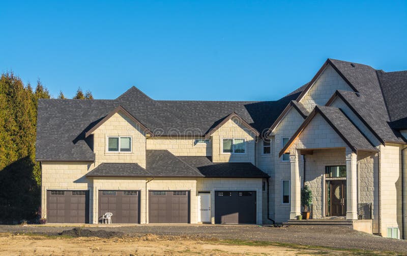 Giant new residential house with four stall garage stock photos Giant new residential house with four stall garage stock photos