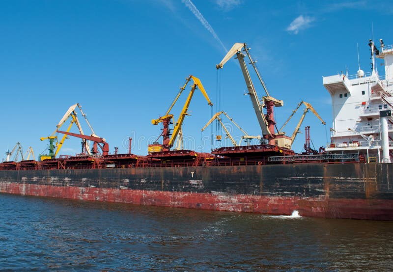 Giant port cranes and a cargo ship