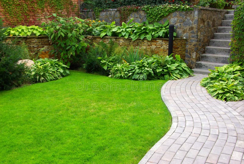 Garden stone path with grass growing up between the stones. Garden stone path with grass growing up between the stones