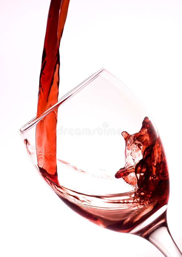Red wine being poured into a wine glass. Red wine being poured into a wine glass.