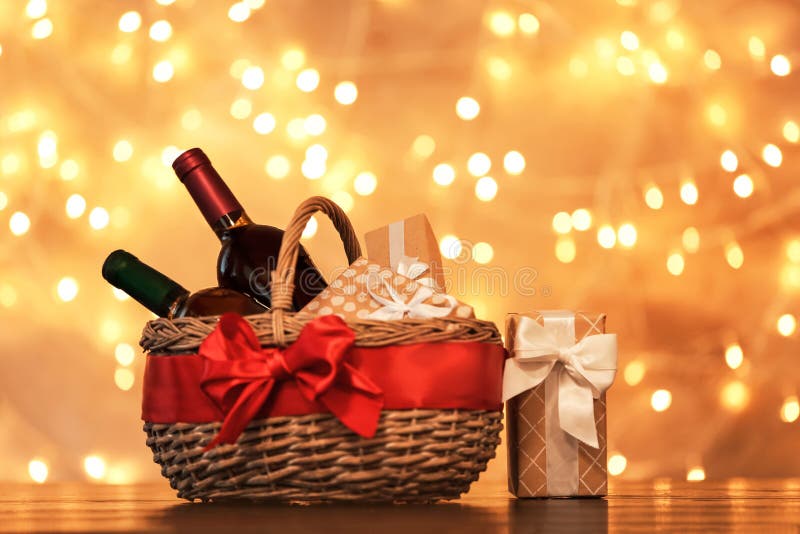 Gift basket with bottles of wine against blurred lights