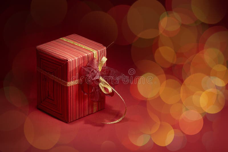 Beautiful Gift Box with Magic Light on Golden Glitters Stock Photo