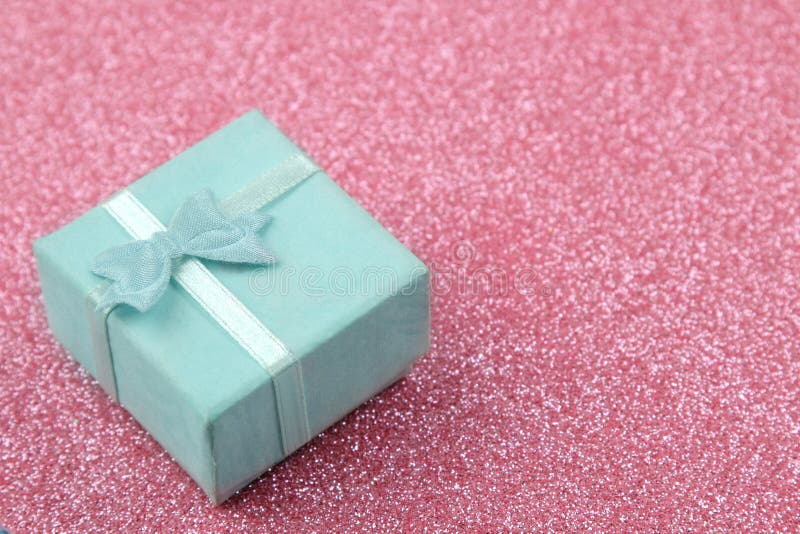 Gift Box Closeup On A Bright Shiny Pink Background