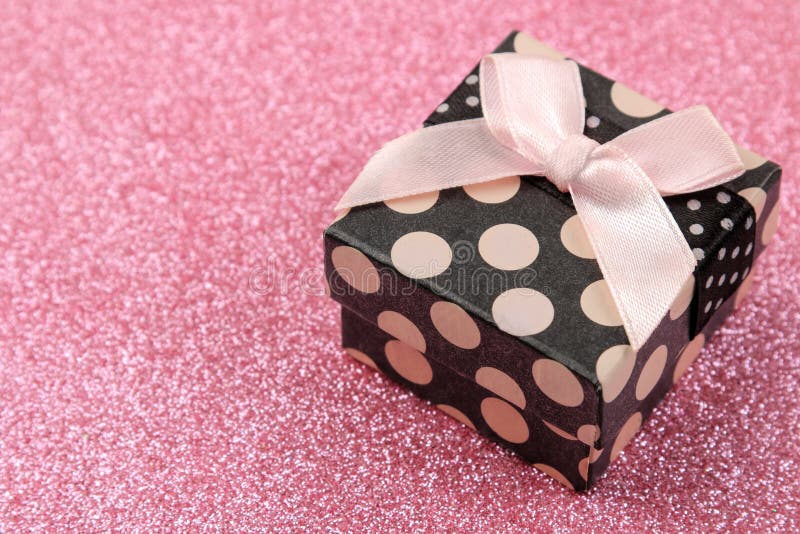 Gift Box Closeup On A Bright Shiny Pink Background