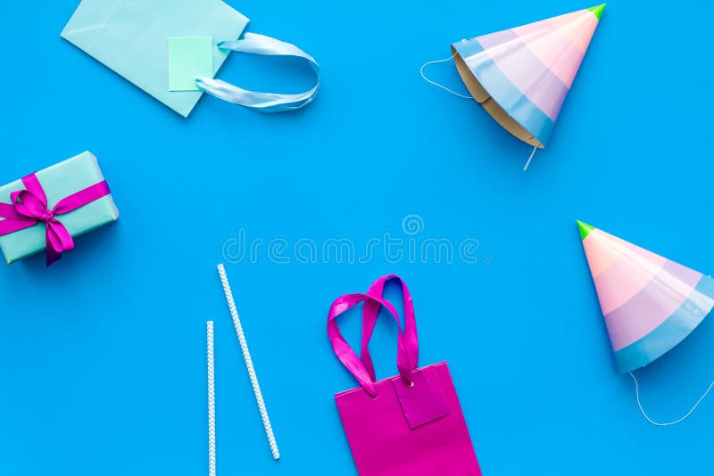 Gift box and colorful paper bag on blue background top view mock-up stock photos Gift box and colorful paper bag on blue background top view mock-up stock photos
