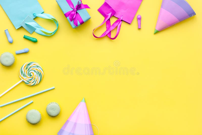 Gift box and colorful paper bag on yellow background top view space for text stock photos Gift box and colorful paper bag on yellow background top view space for text stock photos