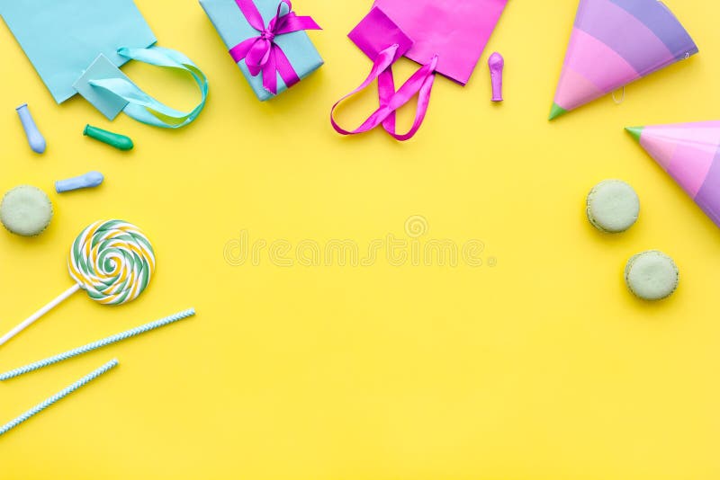 Gift box and colorful paper bag on yellow background top view space for text stock photos Gift box and colorful paper bag on yellow background top view space for text stock photos