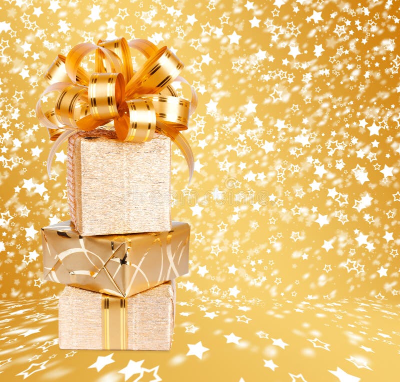 Gift Box in Gold Wrapping Paper on a Beautiful Background Stock Image