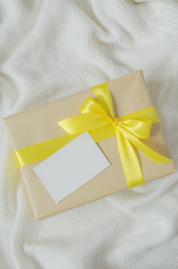 Gift Box. Present with Empty Postcard on Knitted Blanket Background