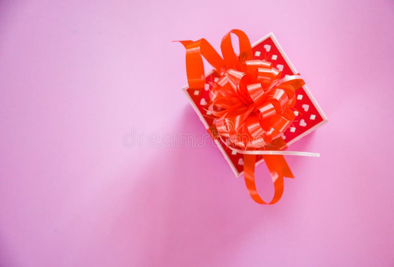 Gift Box red Valentines day concept Red present box with ribbon bow on pink background royalty free stock photo