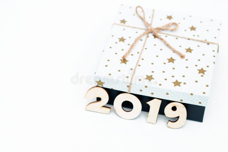 Gift box and symbol numbers 2019 new year on white background, simple flatlay card of new year. Selective focus