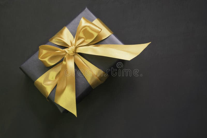 Premium Photo  Black gift wrapped in paper with ribbon on blue background.  copy space. view from above. present for father day. black friday.