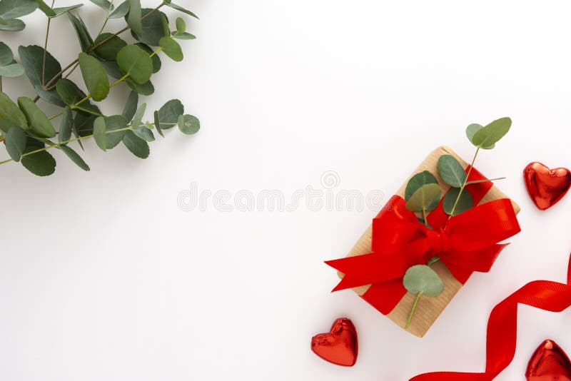 Gift box Wrapped in Brown Recycled Paper with White Ribbon Bow Top View  with Fir Branches. Christmas Concept. Close Up. Stock Photo