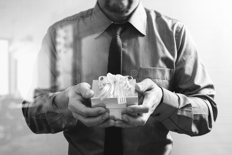 Gift Giving,businessman Hand Holding a Gift Box in a Gesture of Stock