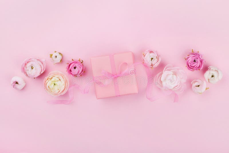 Gift or present box and spring flower on pink desk from above for wedding mockup or greeting card on womans day in flat lay stock images Gift or present box and spring flower on pink desk from above for wedding mockup or greeting card on womans day in flat lay stock images