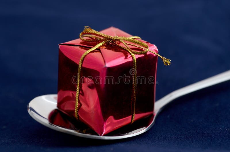 A silver spoon with red gift box. A silver spoon with red gift box.