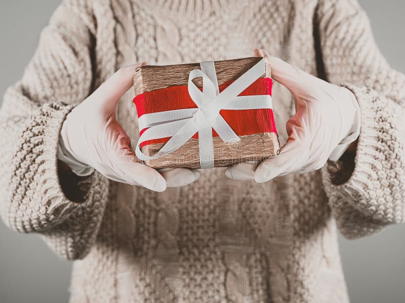 Gift Wrapping with Rubber Gloves. Girl Holding Gift Wrap in Rubber