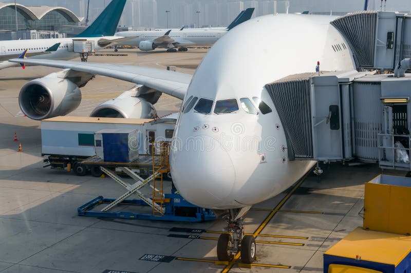 Huge airplane jet connected to terminal via jet bridge. Huge airplane jet connected to terminal via jet bridge.