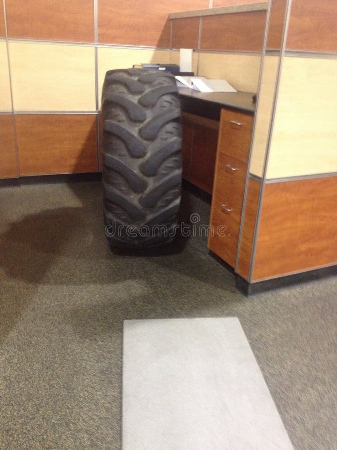 Gigantic Tire Awkwardly Sitting in an Office . High quality photo