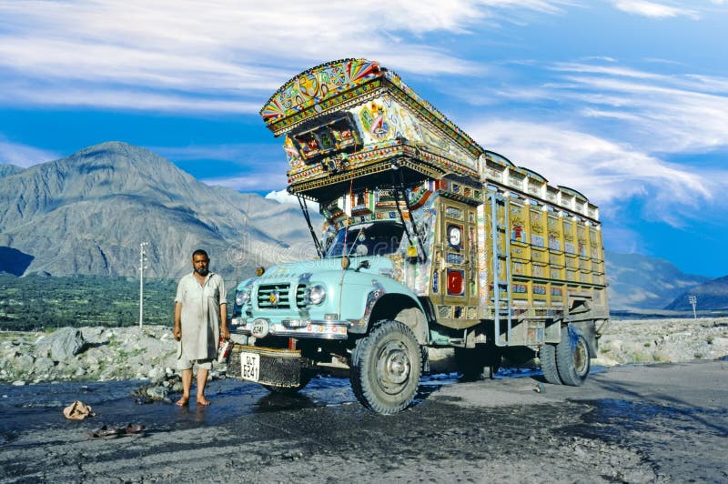 GILGIT, PAQUISTÁN - 6 DE AGOSTO DE 1987: el conductor de camión orgulloso presenta su camión pintado en la carretera del karacoru imagen de archivo GILGIT, PAQUISTÁN - 6 DE AGOSTO DE 1987: el conductor de camión orgulloso presenta su camión pintado en la carretera del karacoru imagen de archivo
