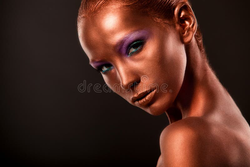 Gilt. Golden Woman's Face Closeup. Futuristic Gilded Make-up. Painted Skin bronze. stock image Gilt. Golden Woman's Face Closeup. Futuristic Gilded Make-up. Painted Skin bronze. stock image