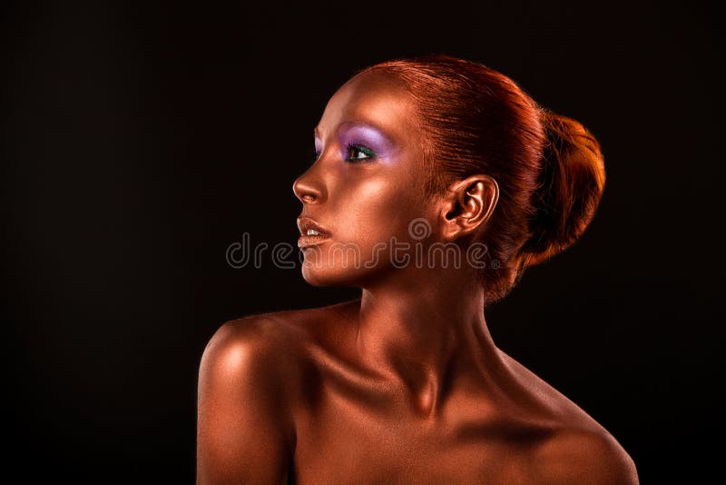 Gilt. Golden Woman's Face Closeup. Futuristic Gilded Make-up. Painted Skin bronze. royalty free stock photo Gilt. Golden Woman's Face Closeup. Futuristic Gilded Make-up. Painted Skin bronze. royalty free stock photo