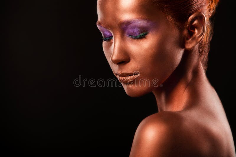 Gilt. Golden Woman's Face Closeup. Futuristic Gilded Make-up. Painted Skin bronze. stock photo Gilt. Golden Woman's Face Closeup. Futuristic Gilded Make-up. Painted Skin bronze. stock photo