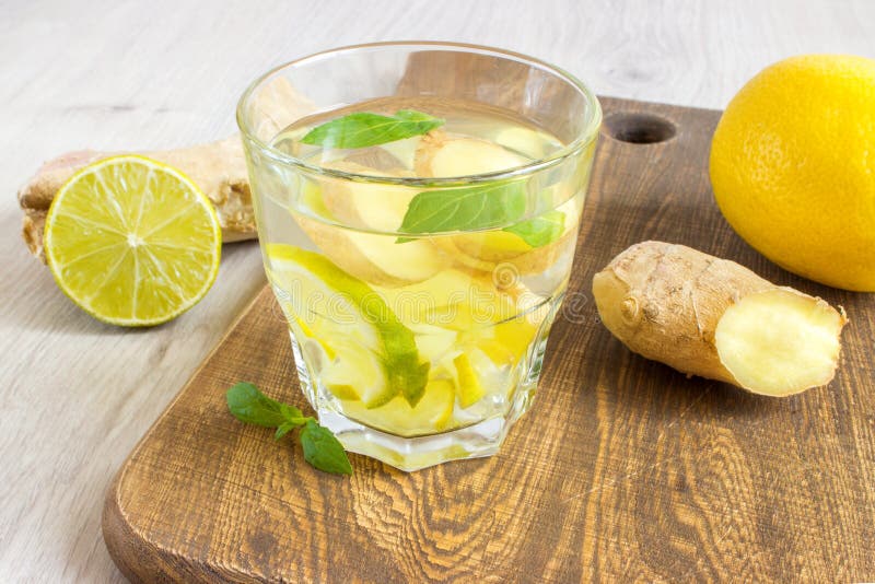 Ginger Ale Soda with Lemon, Mint, Ginger and Ice Over Rustic Wooden
