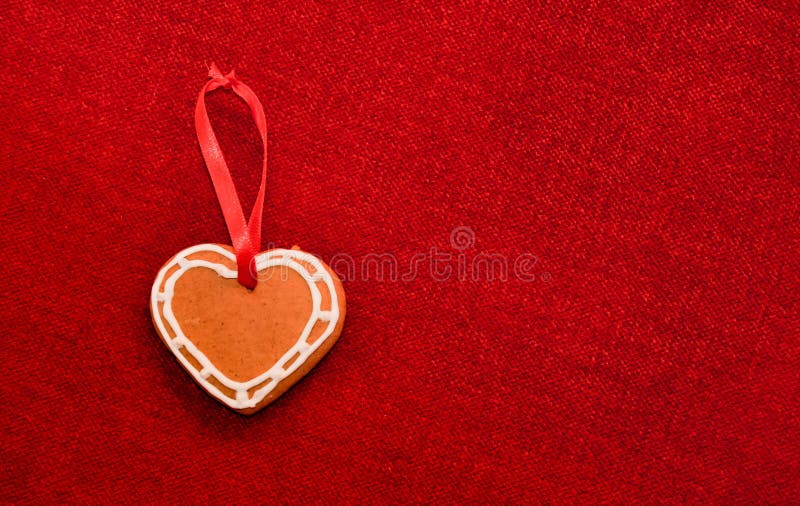 Gingerbread cookie heart and decorative ribbon