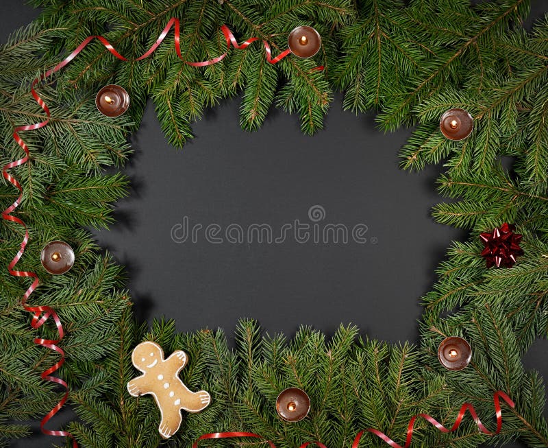 A gingerbread man with Christmas decorations and lots of fir branches royalty free stock image A gingerbread man with Christmas decorations and lots of fir branches royalty free stock image