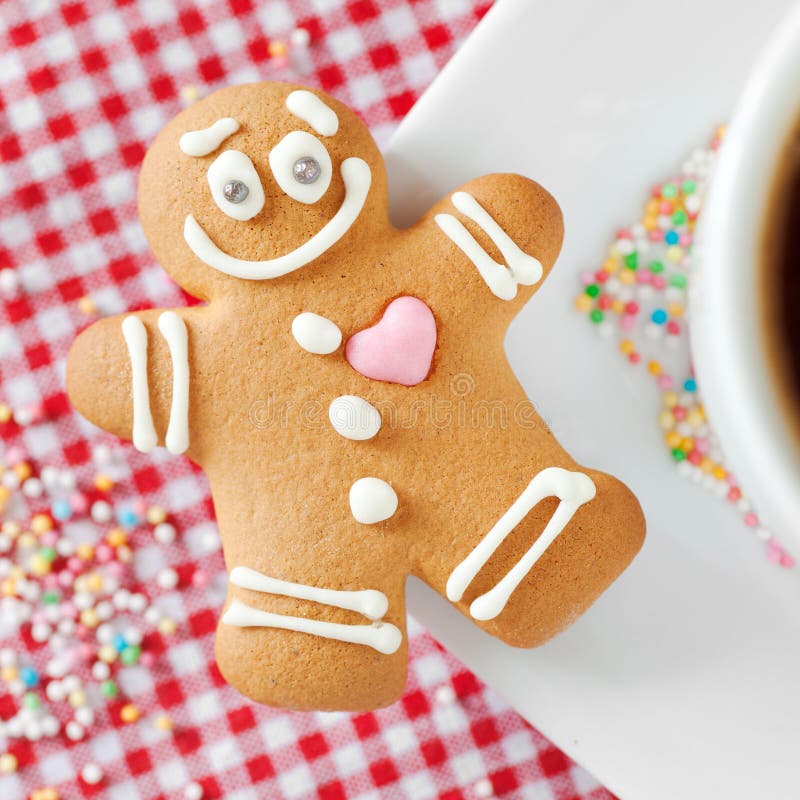 Gingerbread man and coffee cup on table royalty free stock photos