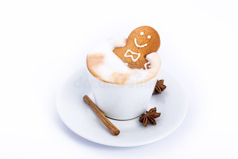 Gingerbread man inside coffee cup isolated on white royalty free stock image