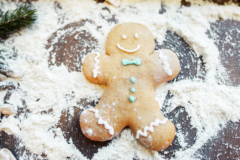 gingerbread-man-making-snow-angel-flour-fun-kitchen-cooking-art-christmas-treat-preparing-79776111.jpg