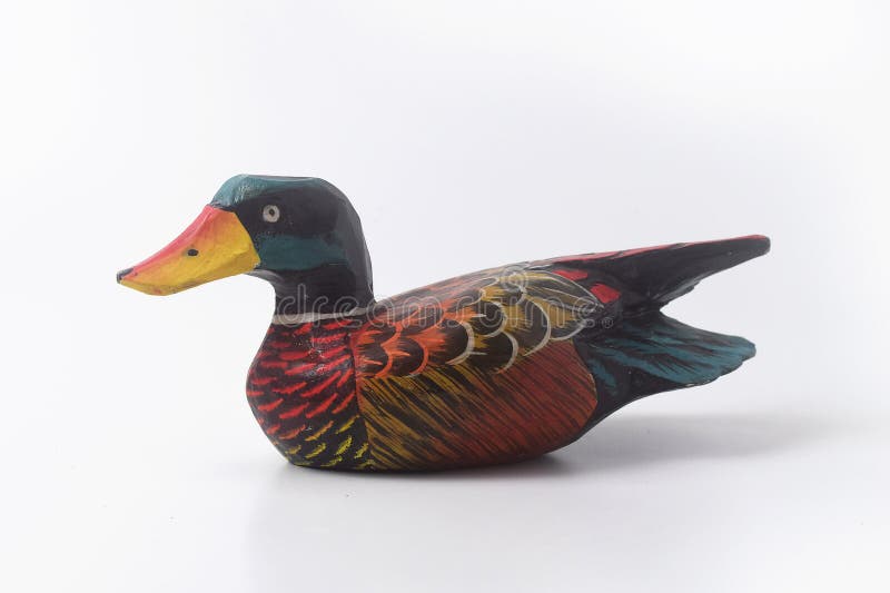 Brebes, Indonesia, June 2, 2023 : An Indonesian duck toy made of wood and painted in an attractive color, Isolated White. Brebes, Indonesia, June 2, 2023 : An Indonesian duck toy made of wood and painted in an attractive color, Isolated White