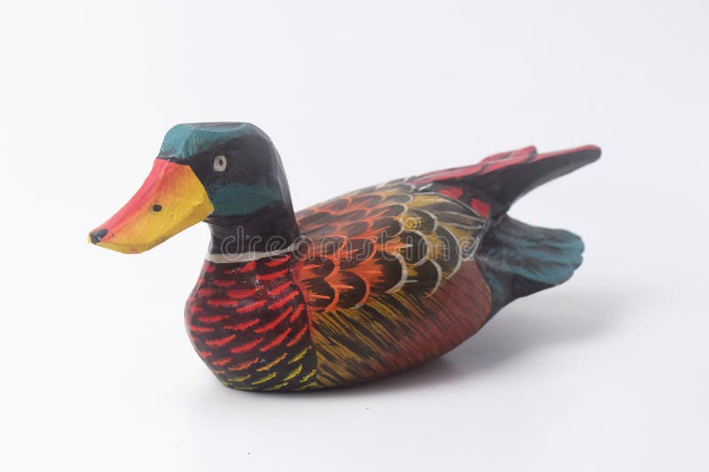 Brebes, Indonesia, June 2, 2023 : An Indonesian duck toy made of wood and painted in an attractive color, Isolated White. Brebes, Indonesia, June 2, 2023 : An Indonesian duck toy made of wood and painted in an attractive color, Isolated White