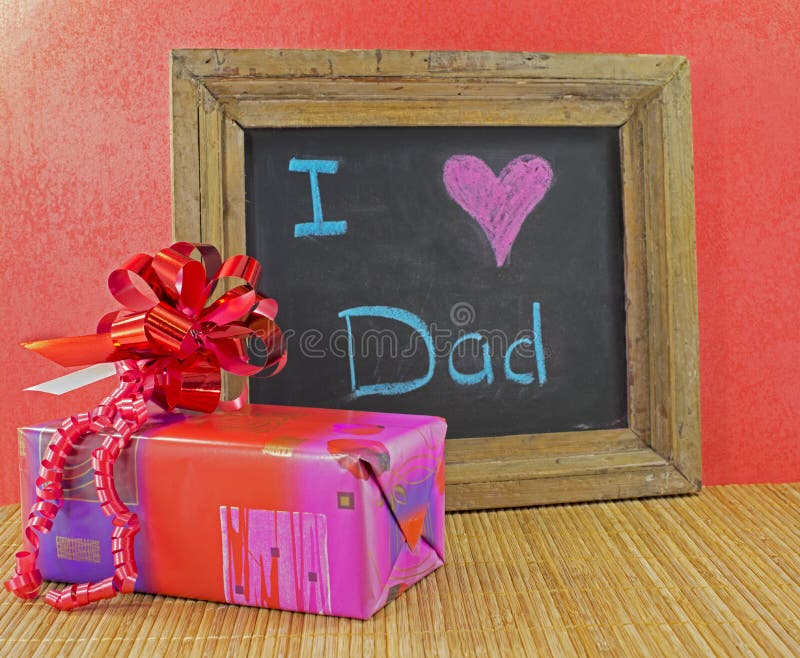 Happy fathers day with present and blackboard with text i love dad. Happy fathers day with present and blackboard with text i love dad