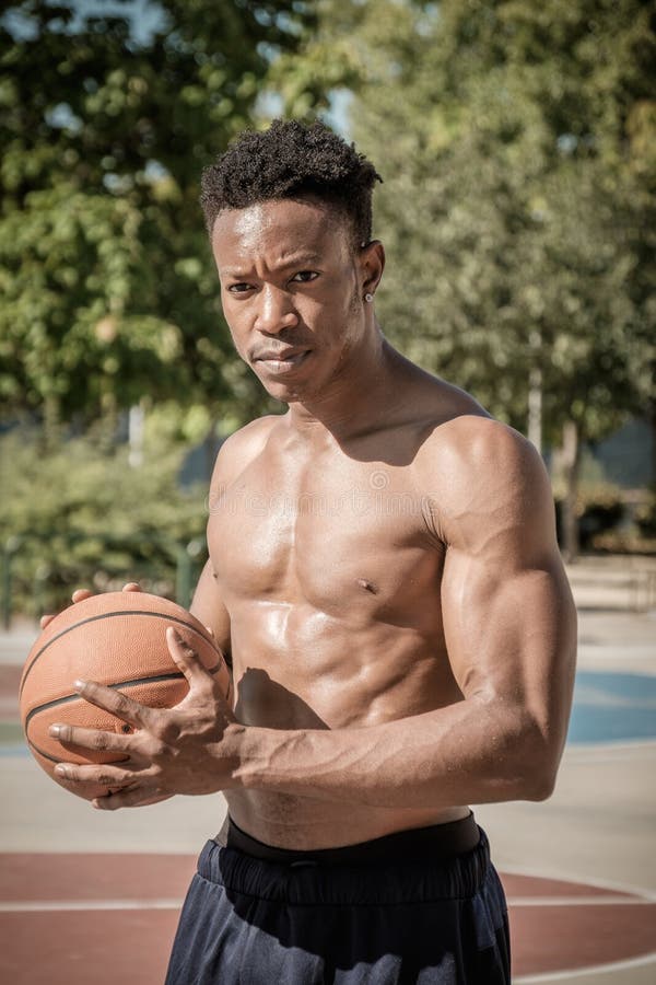 Giovane afroamericano che gioca pallacanestro della via nel parco immagine stock libera da diritti Giovane afroamericano che gioca pallacanestro della via nel parco immagine stock libera da diritti