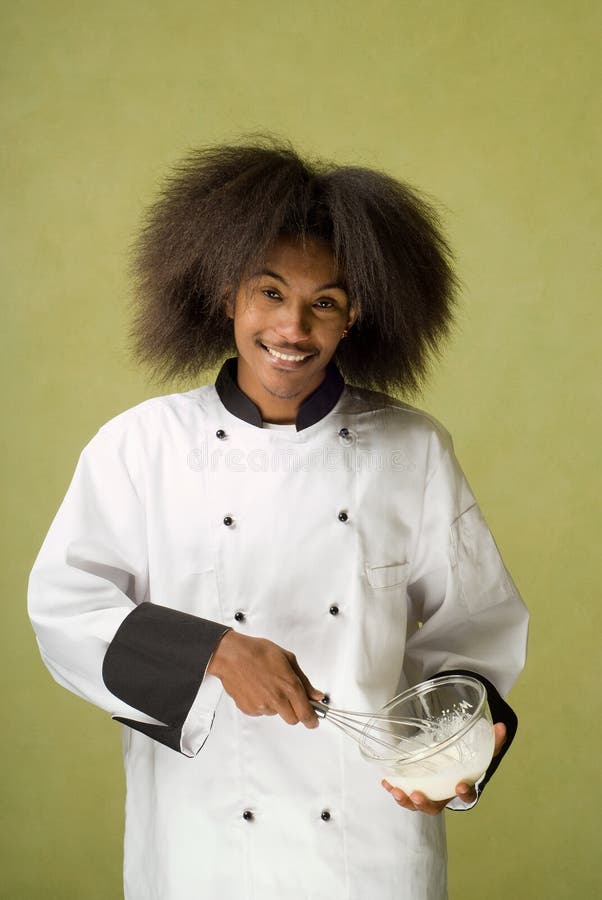 Happy Young African American Chef Whisking Cream in Glass Bowl. Happy Young African American Chef Whisking Cream in Glass Bowl