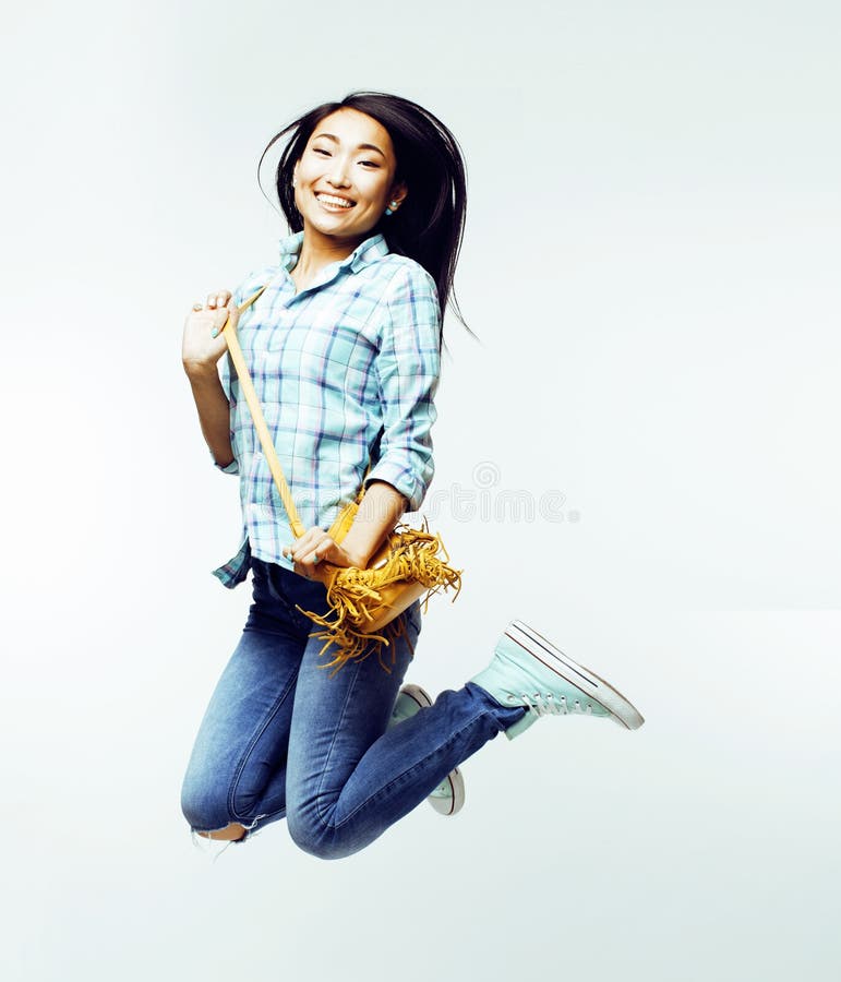 Young pretty jumping asian woman posing cheerful emotional isolated on white background, lifestyle people concept close up. Young pretty jumping asian woman posing cheerful emotional isolated on white background, lifestyle people concept close up