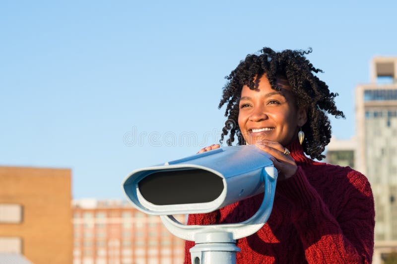 Giovane donna che per mezzo del binocolo fotografia stock libera da diritti Giovane donna che per mezzo del binocolo fotografia stock libera da diritti