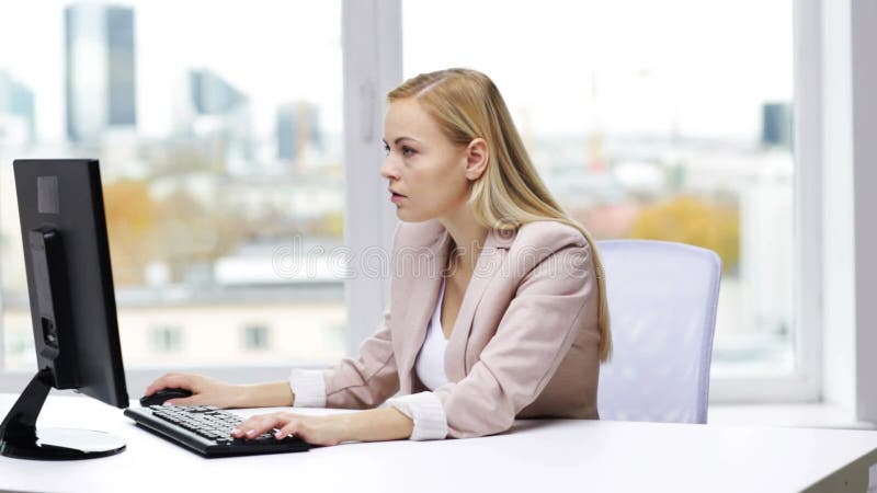 Giovane donna di affari con il computer che scrive all'ufficio