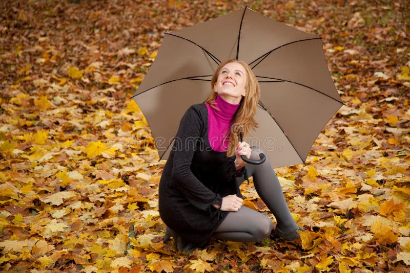 Giovane donna di redhead con l'ombrello