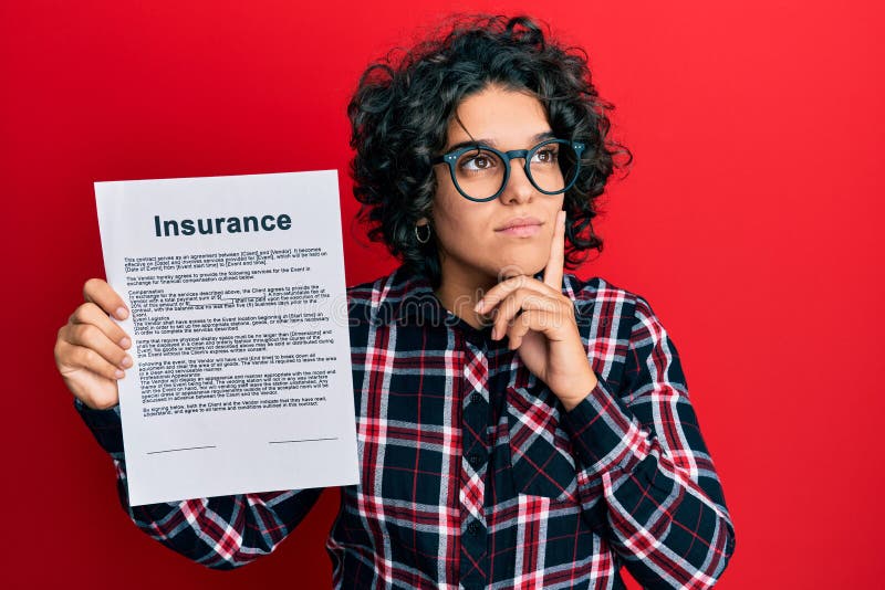 Young hispanic woman with curly hair holding insurance document serious face thinking about question with hand on chin, thoughtful about confusing idea. Young hispanic woman with curly hair holding insurance document serious face thinking about question with hand on chin, thoughtful about confusing idea