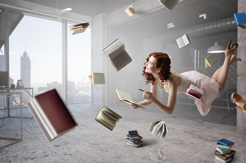 Giovane donna levita mentre legge un libro fotografia stock libera da diritti