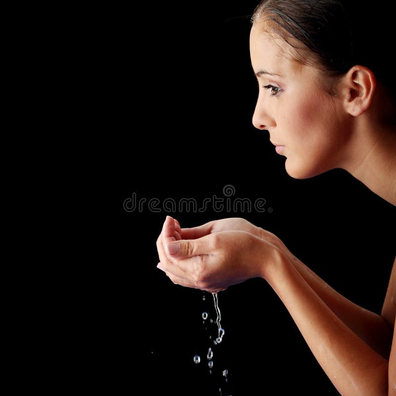 Young teen woman washing her face with clean water. Young teen woman washing her face with clean water