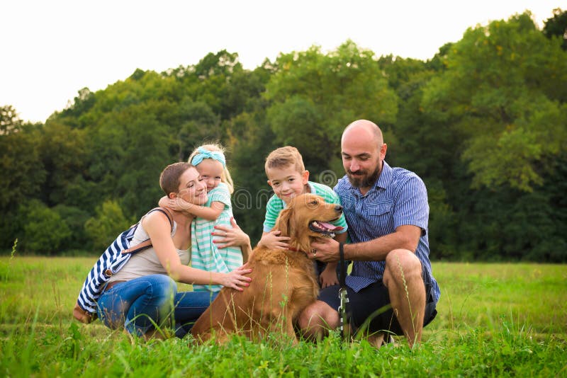 Beautiful young family with their pet dog, golden retriever. Beautiful young family with their pet dog, golden retriever