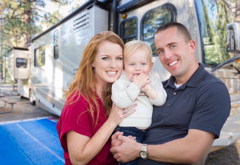 Happy Young Military Family In Front of Their Beautiful RV At The Campground. Happy Young Military Family In Front of Their Beautiful RV At The Campground.
