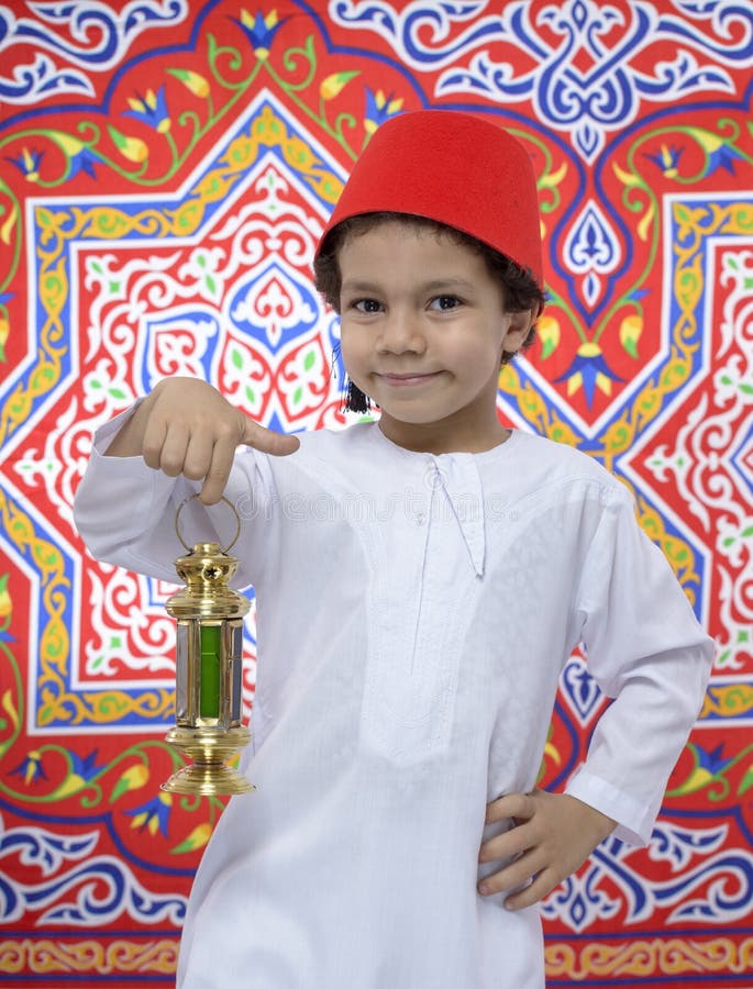 Giovane ragazzo felice con Fes e lanterna che celebrano il Ramadan